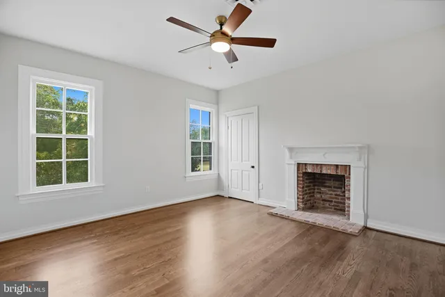a view of wooden floor and windows in a room