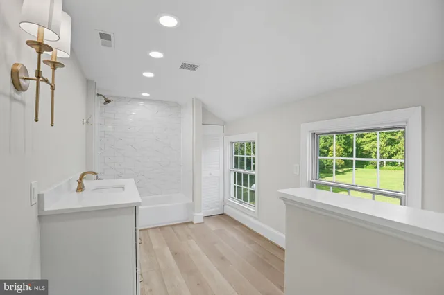 a view of a room with wooden floor and windows