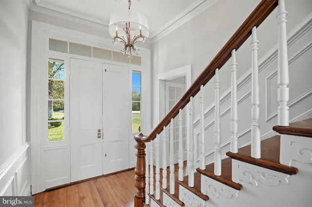 a view of entryway with stairs and wooden floor