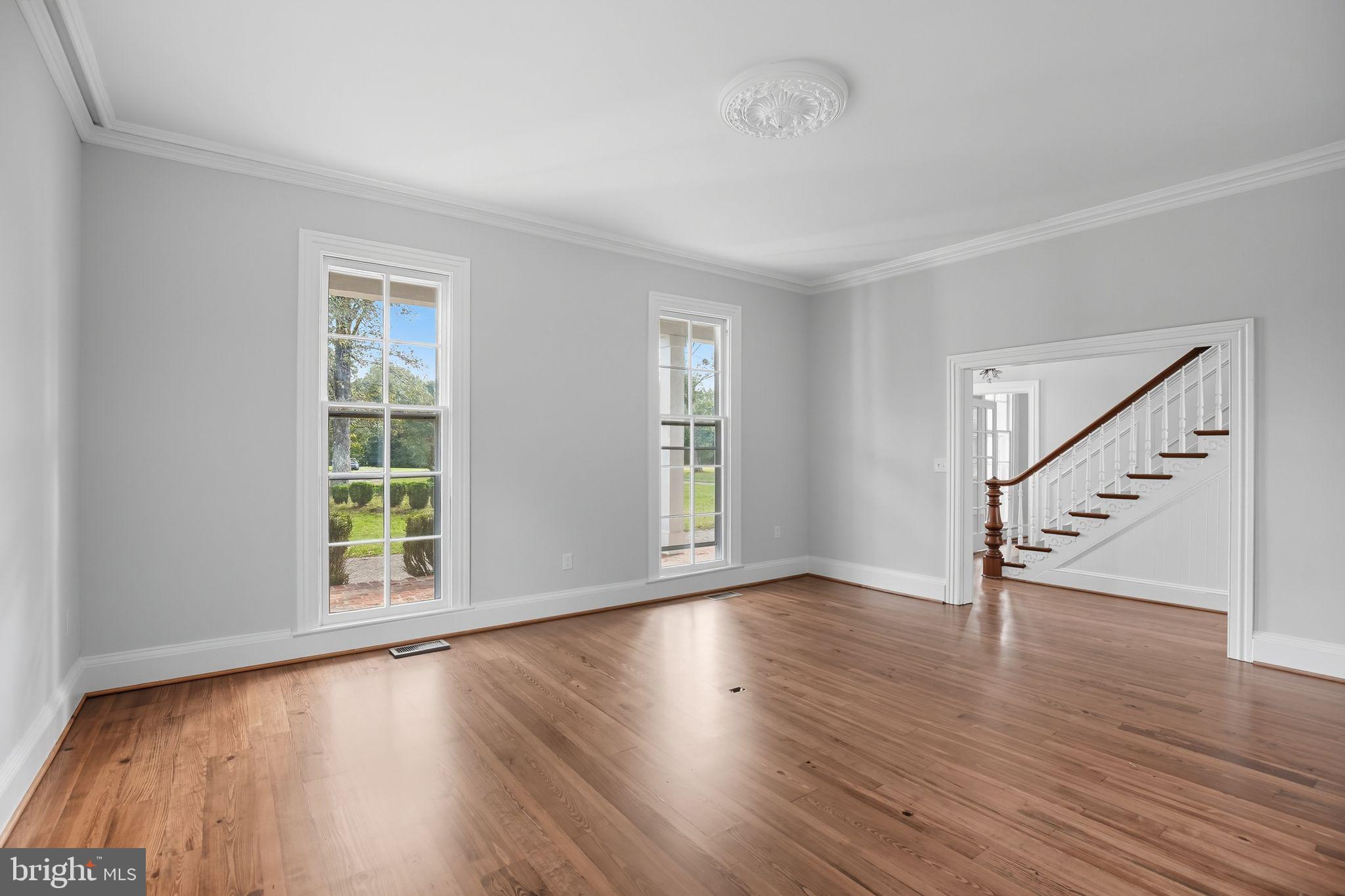 5965 Acorn Spring Place La Plata, MD 20646 - Photo 8 of 54 a view of an empty room with wooden floor and a window