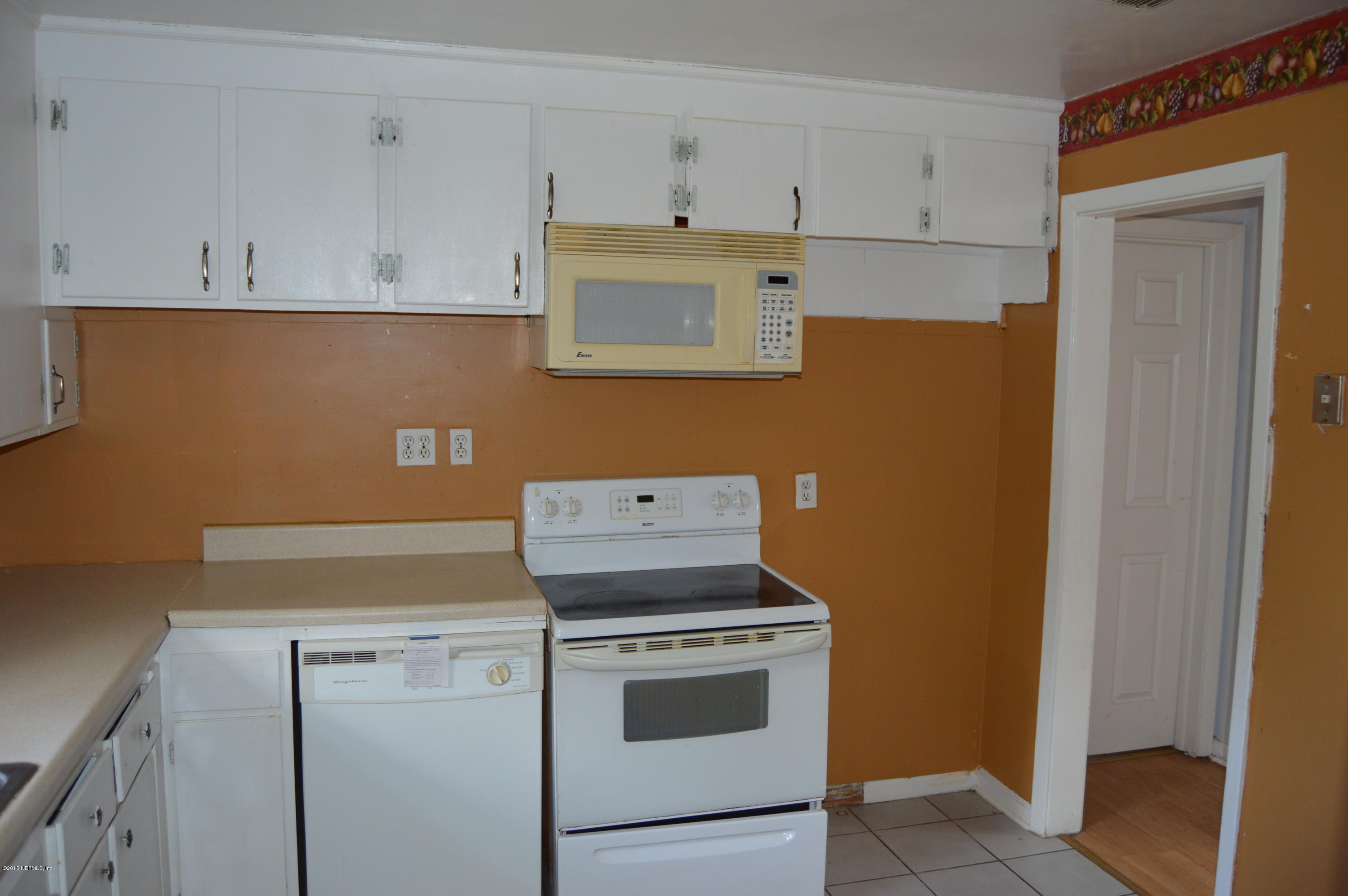 2236 Dean Road Jacksonville, FL 32216 - Photo 11 of 21 a stove top oven sitting inside of a kitchen