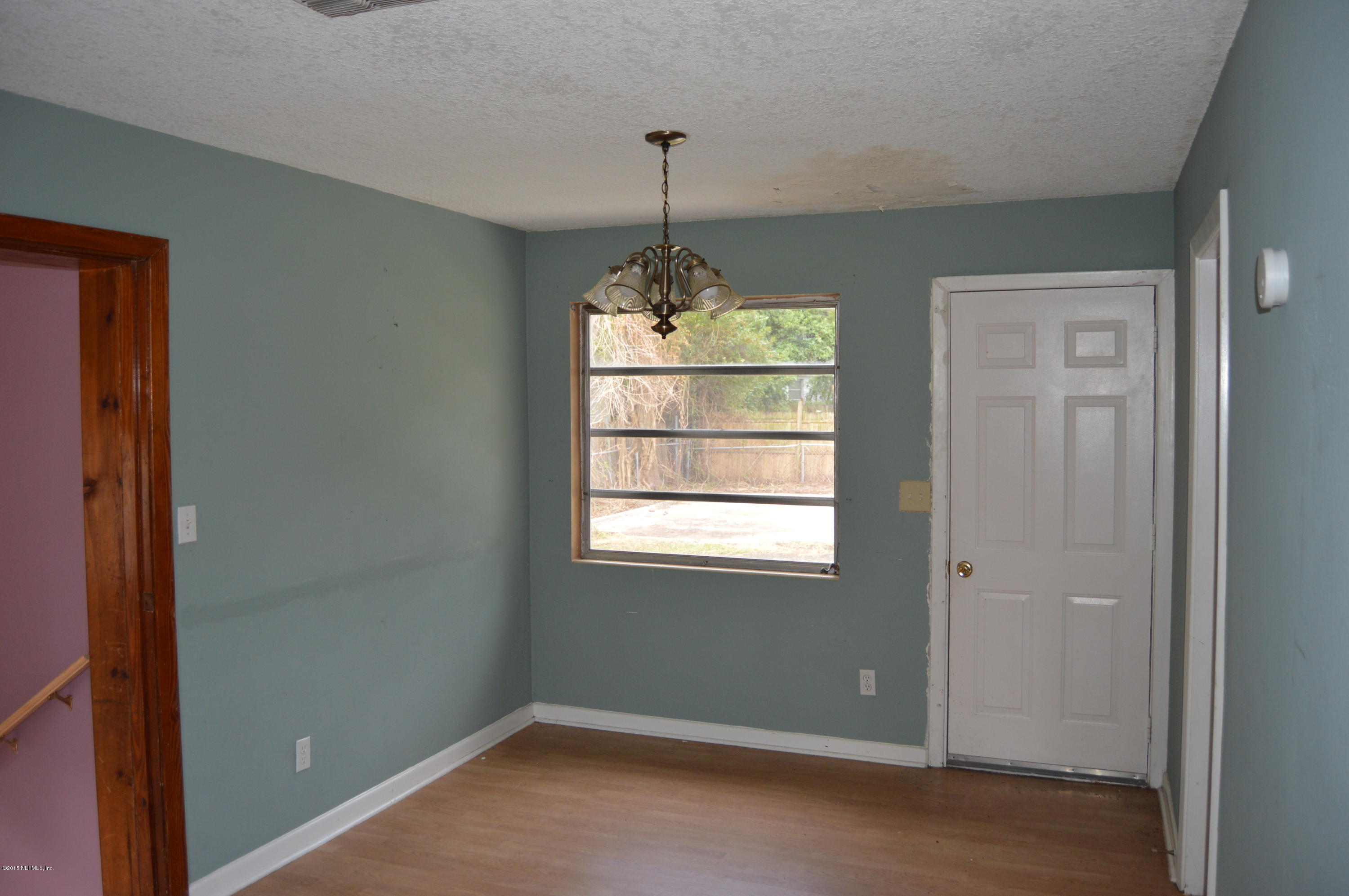 2236 Dean Road Jacksonville, FL 32216 - Photo 14 of 21 a room that has a chandelier and window in it