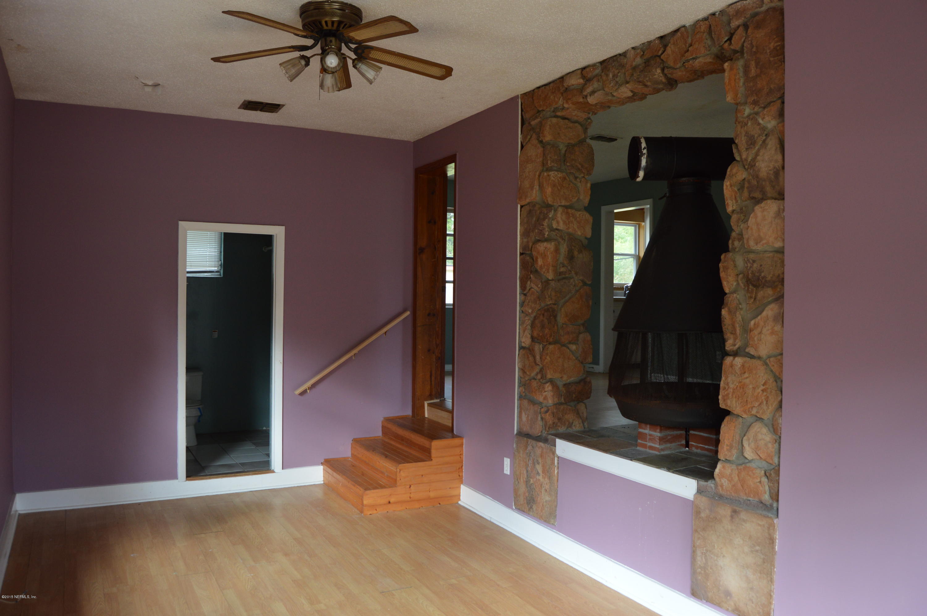 2236 Dean Road Jacksonville, FL 32216 - Photo 19 of 21 a view of a hallway with a dining table and chandelier