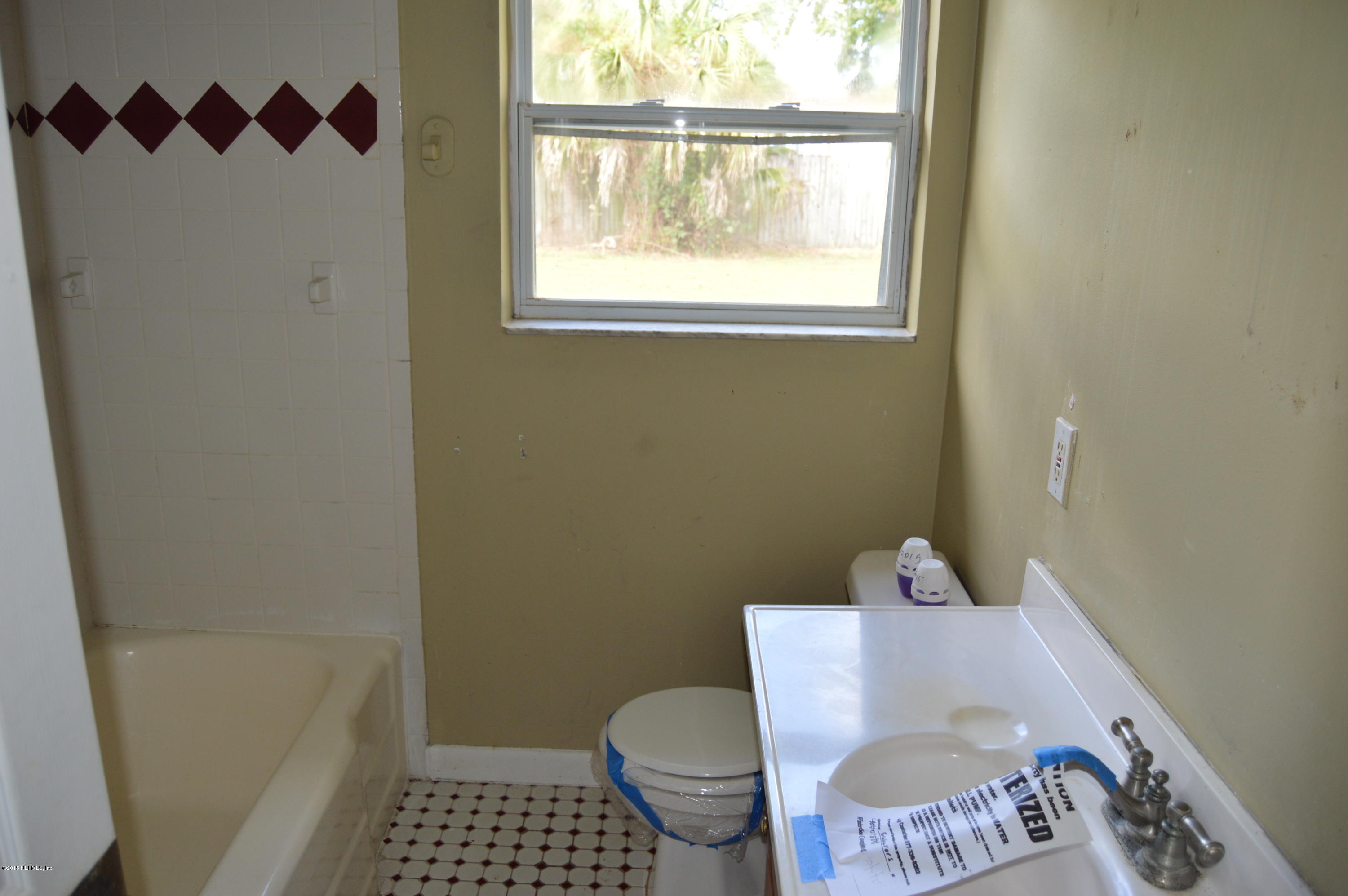 2236 Dean Road Jacksonville, FL 32216 - Photo 4 of 21 a bathroom with a toilet and a shower curtain