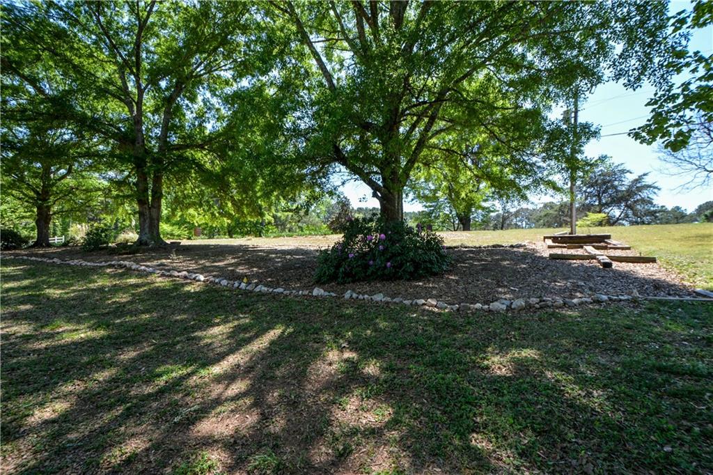 130 Hawn Road Fayetteville, GA 30215 - Photo 60 of 67 a view of outdoor space with green field and trees all around