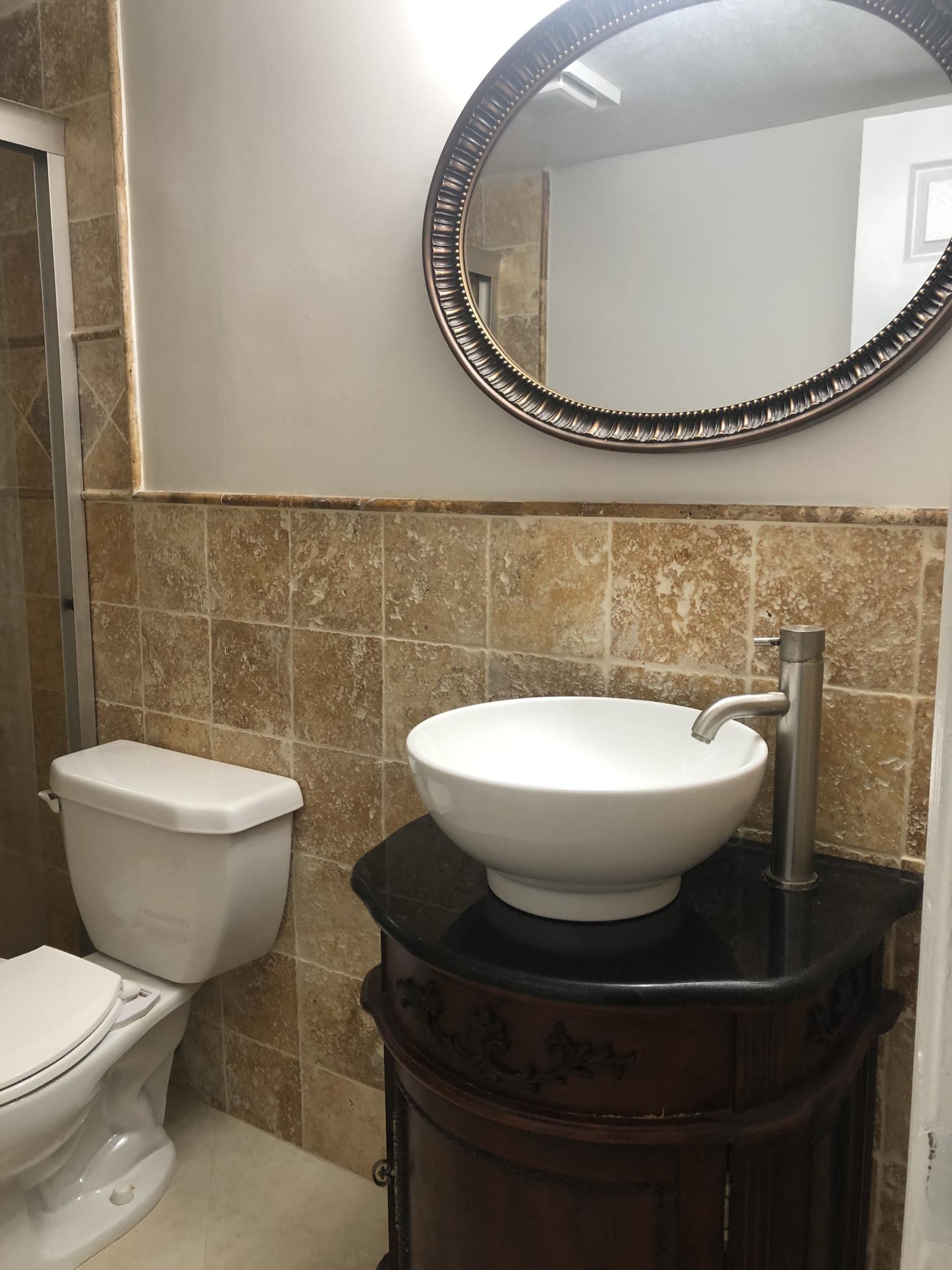 1291 Northwest 13th Street, Unit 346D Boca Raton, FL 33486 - Photo 12 of 15 a bathroom with a toilet and a mirror