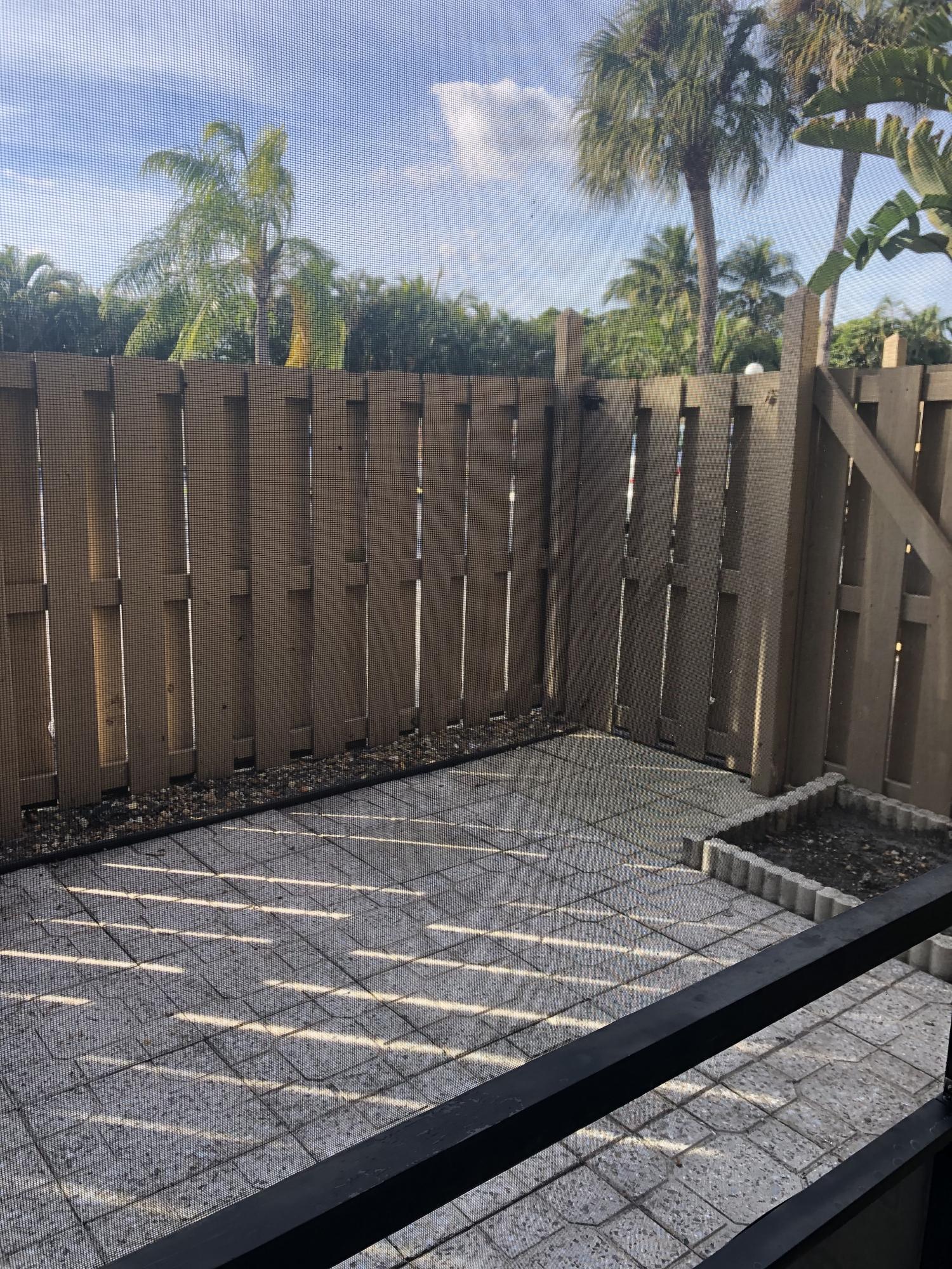 1291 Northwest 13th Street, Unit 346D Boca Raton, FL 33486 - Photo 15 of 15 a wooden door with view of palm trees