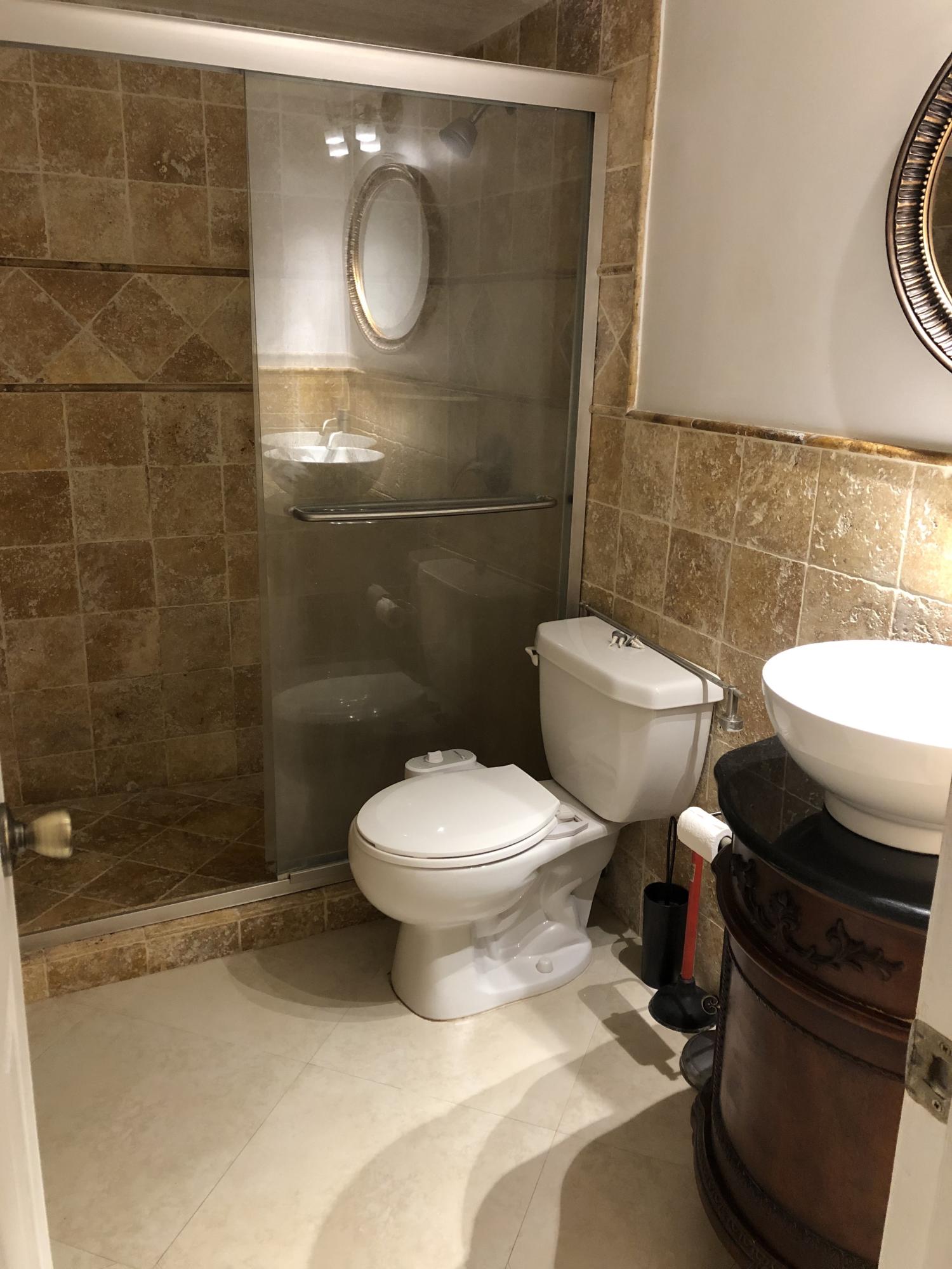 1291 Northwest 13th Street, Unit 346D Boca Raton, FL 33486 - Photo 10 of 15 a bathroom with a toilet and a shower