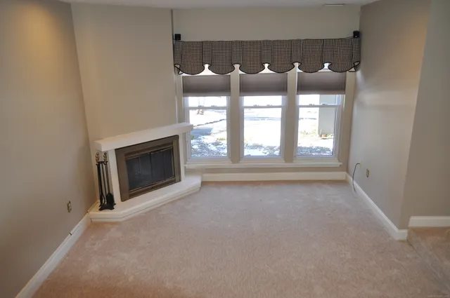 a view of fireplace and window in a room