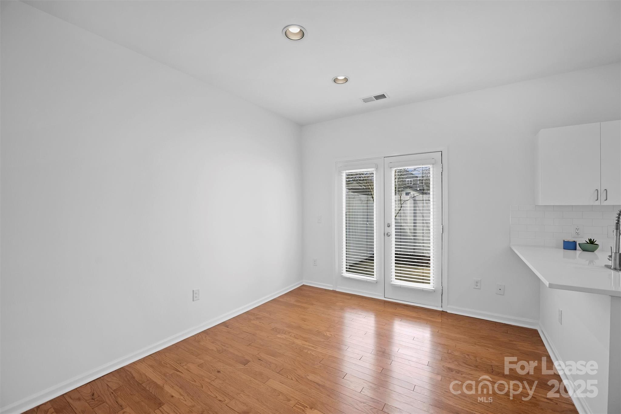 2252 Vision Drive Charlotte, NC 28203 - Photo 16 of 30 an empty room with wooden floor and windows