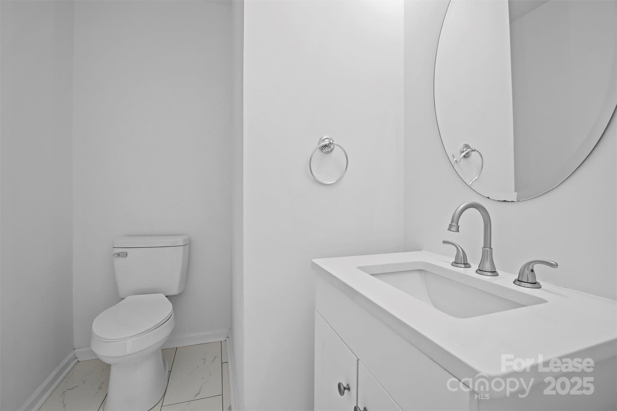 2252 Vision Drive Charlotte, NC 28203 - Photo 17 of 30 a bathroom with a toilet sink and mirror