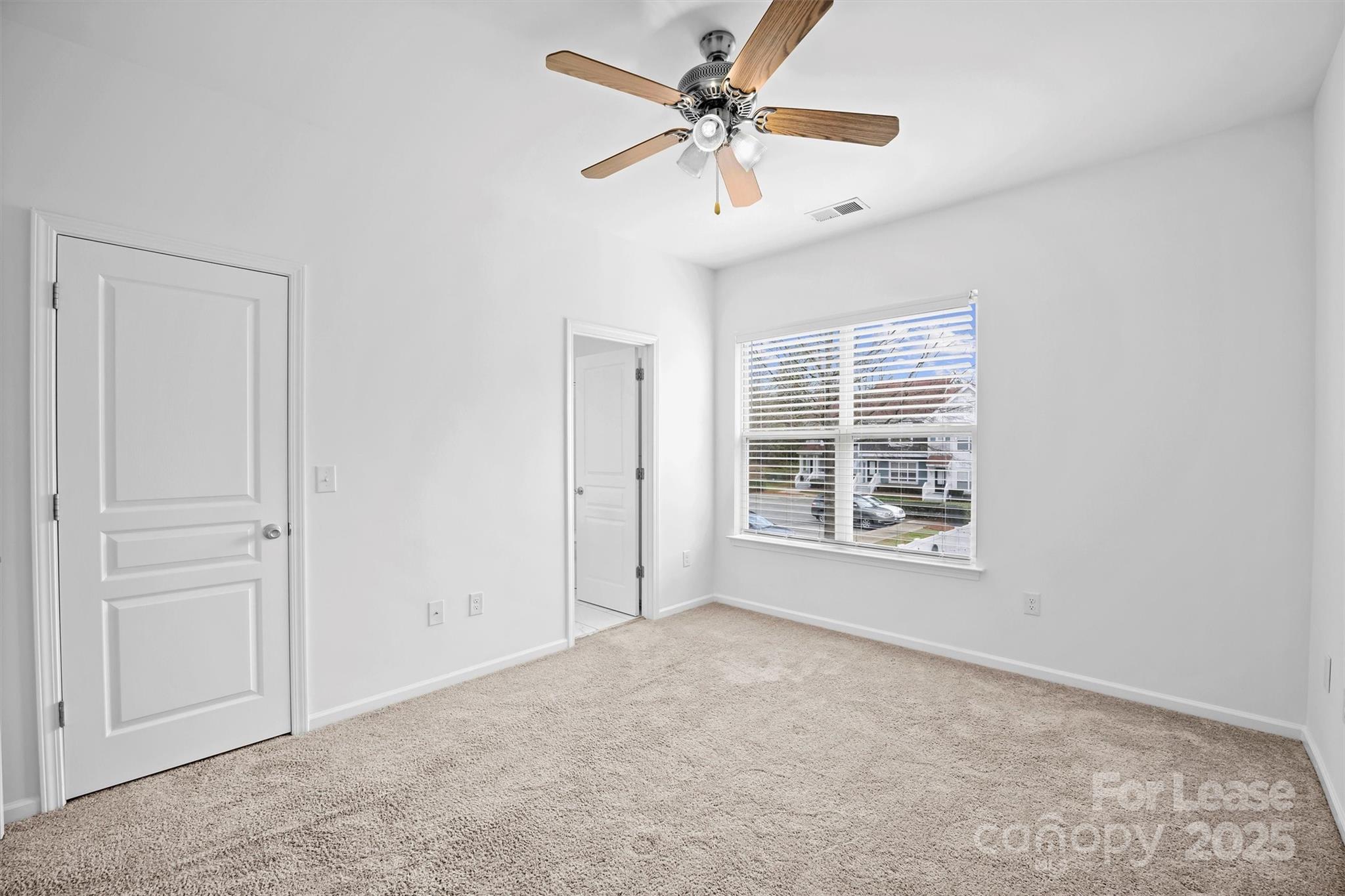 2252 Vision Drive Charlotte, NC 28203 - Photo 19 of 30 an empty room with windows and fan