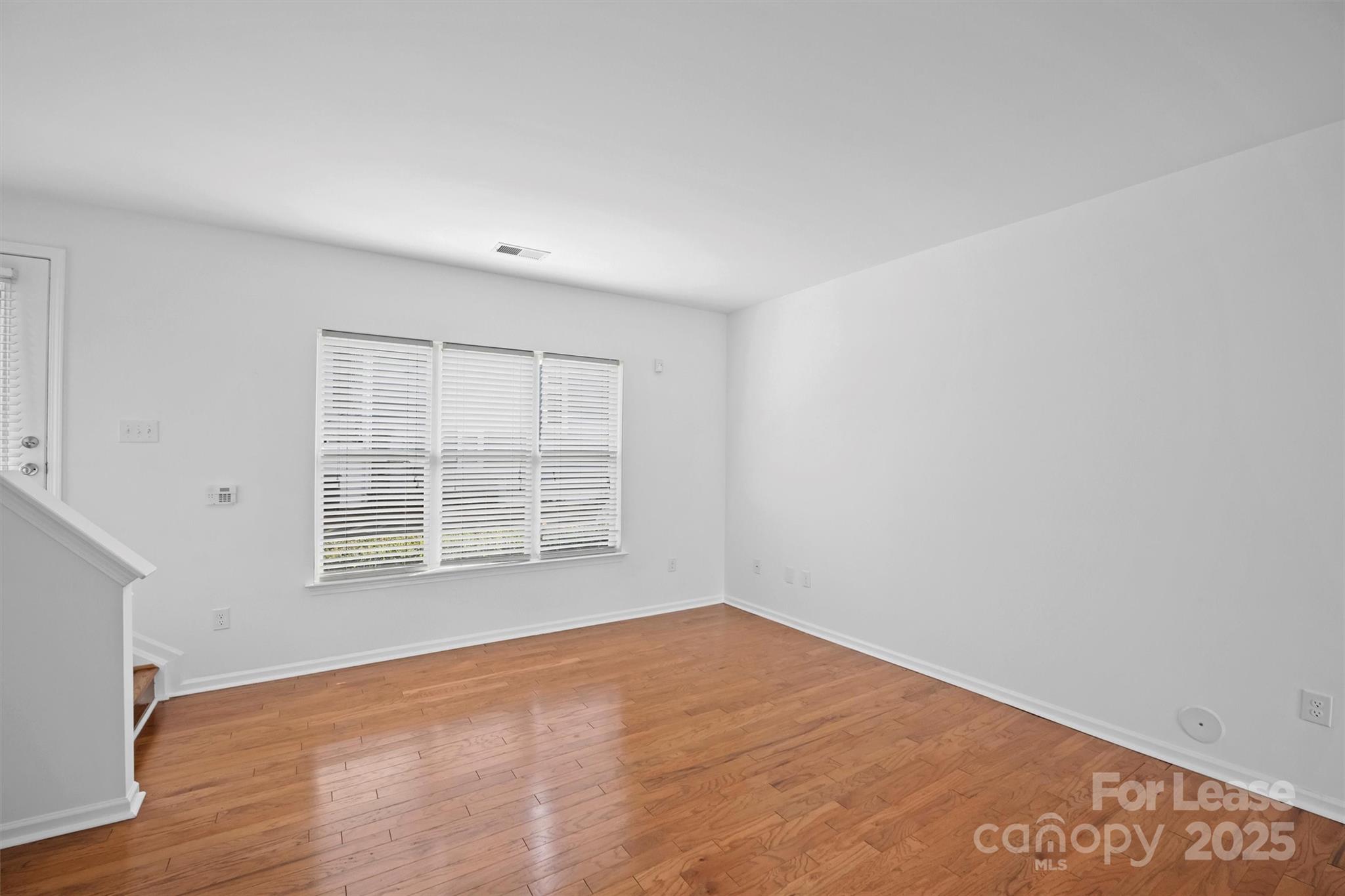 2252 Vision Drive Charlotte, NC 28203 - Photo 8 of 30 a view of an empty room with wooden floor and a window