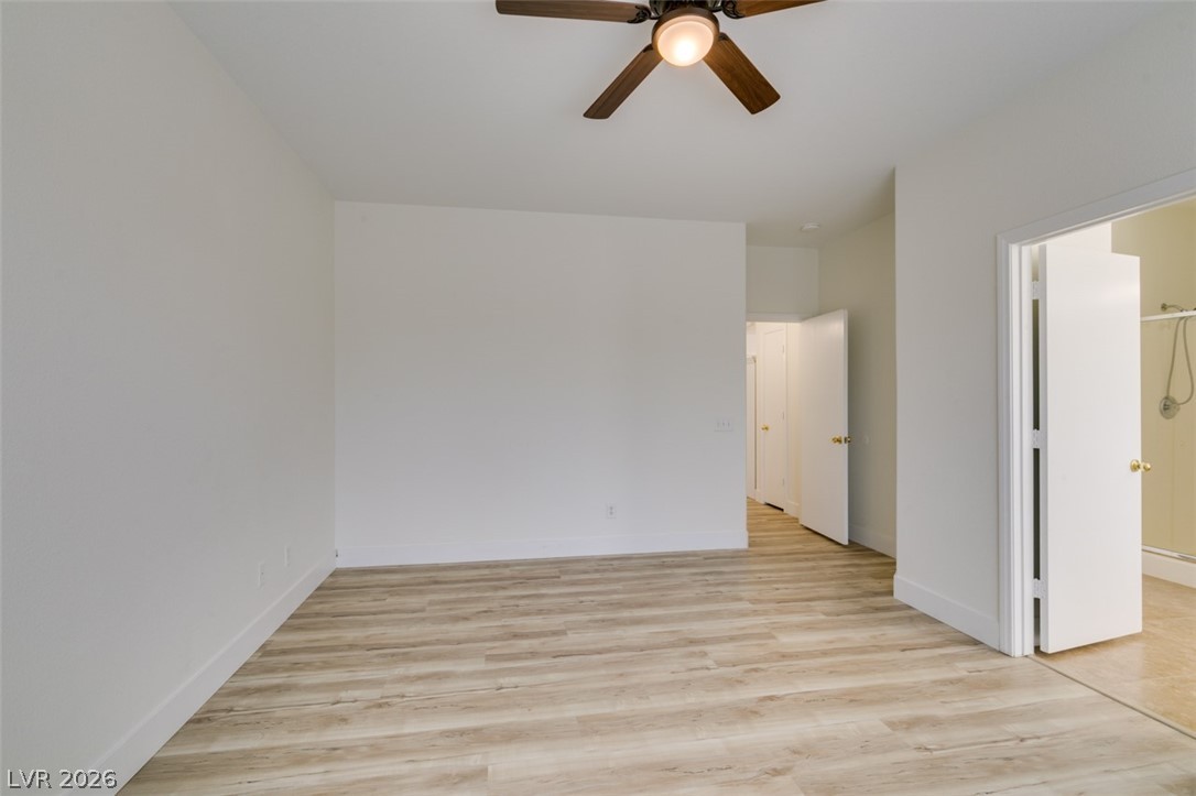10959 Pumpkin Ridge Avenue Las Vegas, NV 89135 - Photo 26 of 51 A spacious bedroom features neutral tones and durable flooring, perfect for personalization.