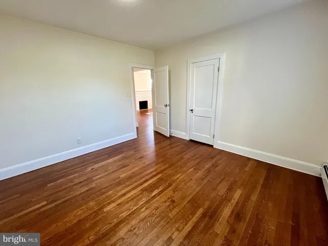 a view of an empty room and wooden floor
