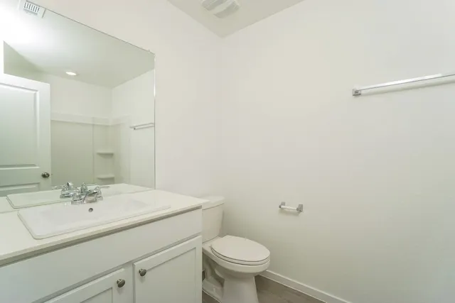 a bathroom with a sink toilet and a mirror
