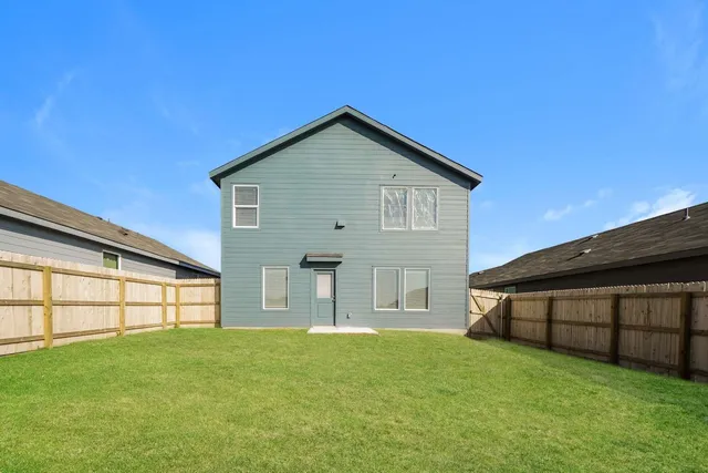 a view of a house with a backyard