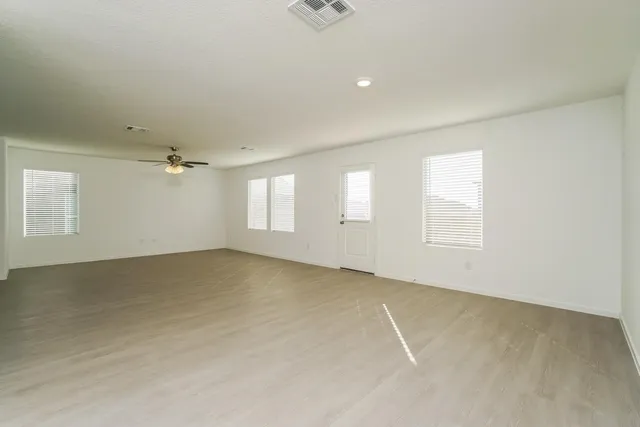 an empty room with windows and closet