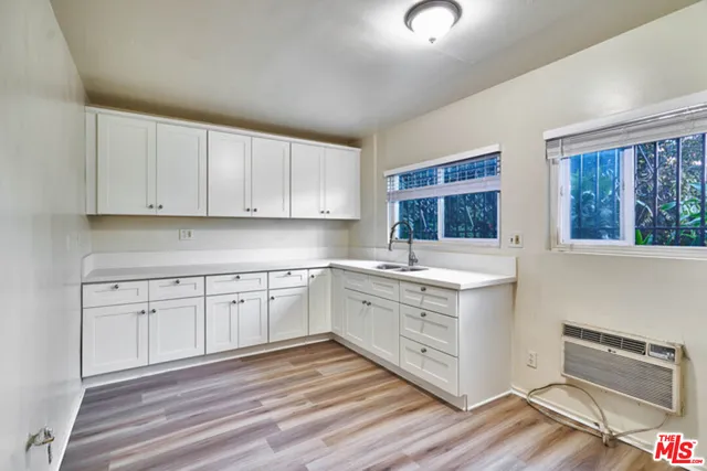 a kitchen with granite countertop white cabinets and white appliances