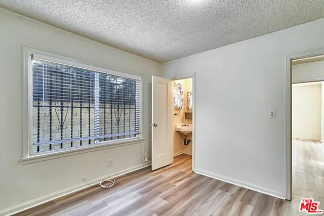 a view of an empty room with glass door
