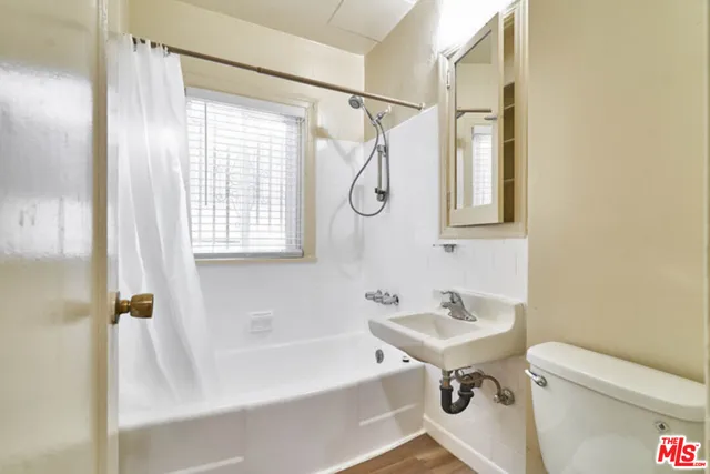 a bathroom with a sink a toilet and a bathtub