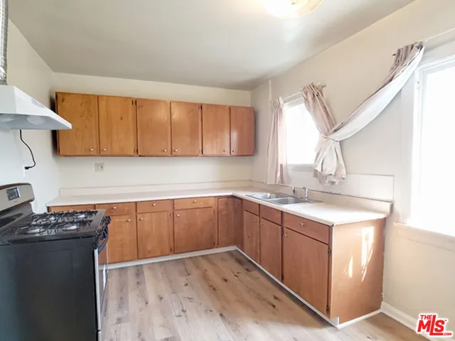 a kitchen with a sink stove and cabinets