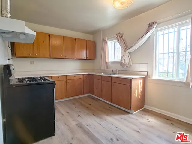 a kitchen with a sink cabinets and a window
