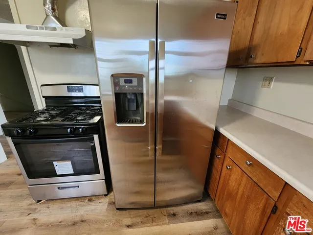 a kitchen with a refrigerator and a counter