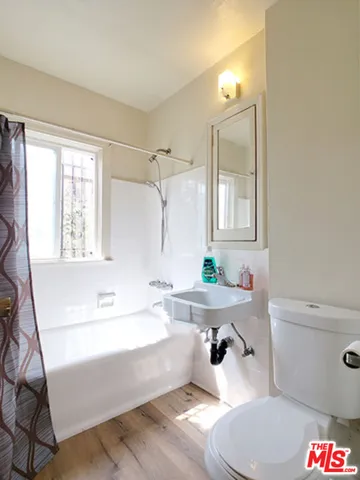 a bathroom with a sink a toilet and a bathtub