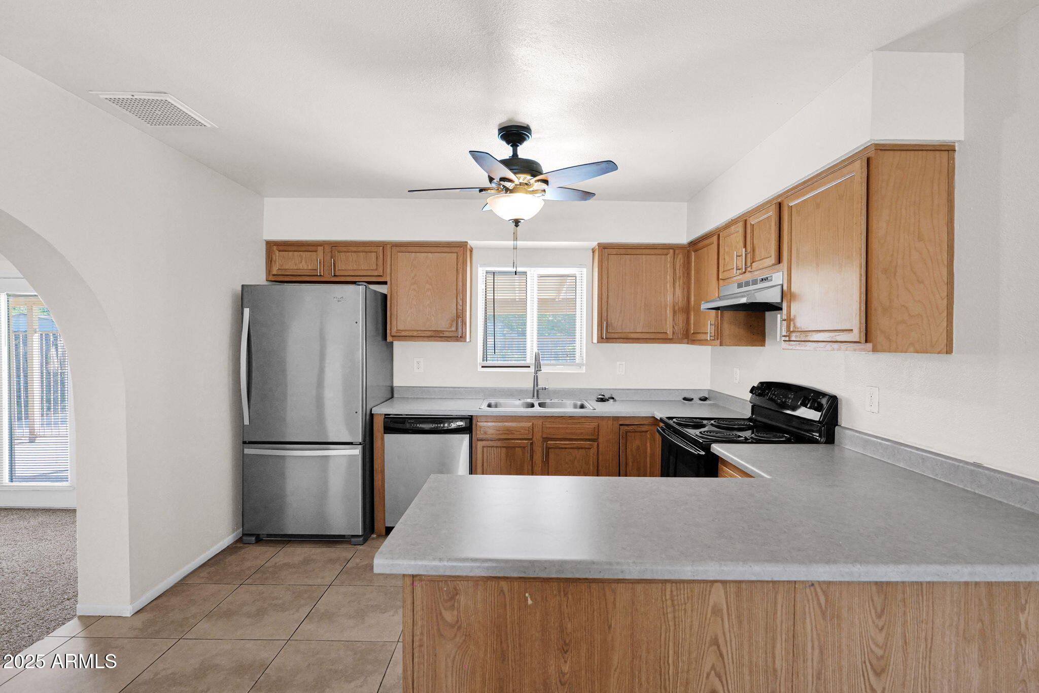 7221 Virginia Avenue Phoenix, AZ 85035 - Photo 9 of 33 a kitchen with stainless steel appliances granite countertop a refrigerator sink and cabinets