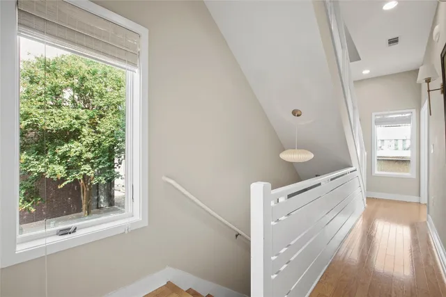 a bathroom with a granite countertop sink a toilet a mirror and shower