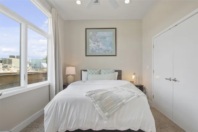 a front view of a building with cars parked