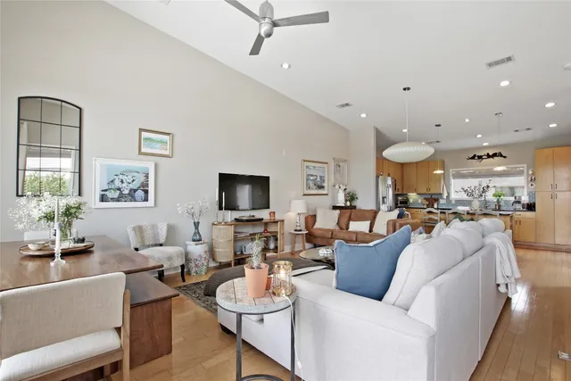 a view of a dining room with furniture wooden floor and a chandelier