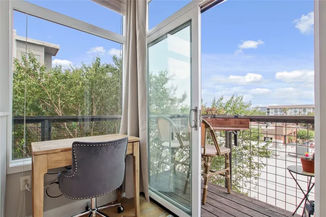 a bedroom with a bed tv and a window