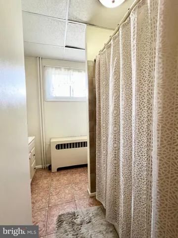 a bathroom with a bathtub and shower