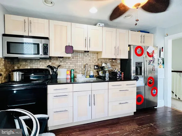 a kitchen with kitchen island granite countertop a sink and a stove