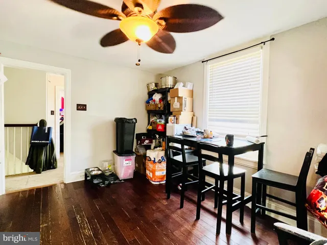 a view of a workspace with furniture and wooden floor