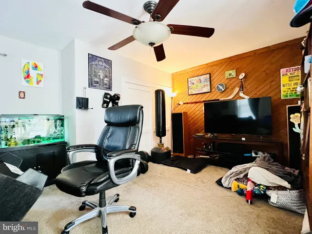 a room with gym equipment and a flat screen tv