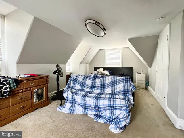 a living room with furniture gym equipment and a mirror