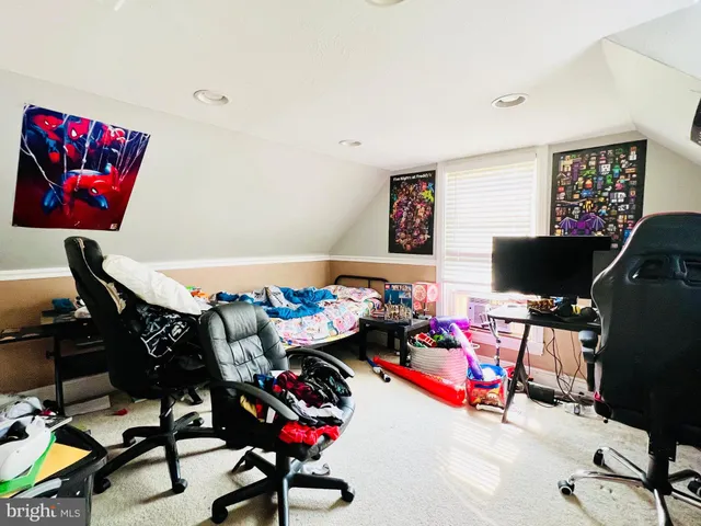 a living room with furniture a rug and a flat screen tv
