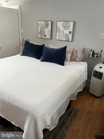 a bed room with a bed and a chair