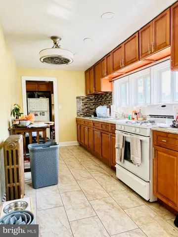 a kitchen with stainless steel appliances a stove a sink and a refrigerator