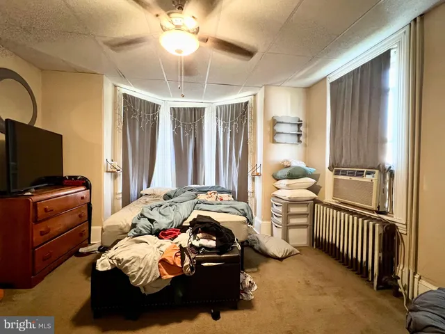 a bedroom with furniture and a window