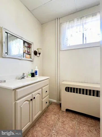 a bathroom with a double vanity sink a mirror and bathtub