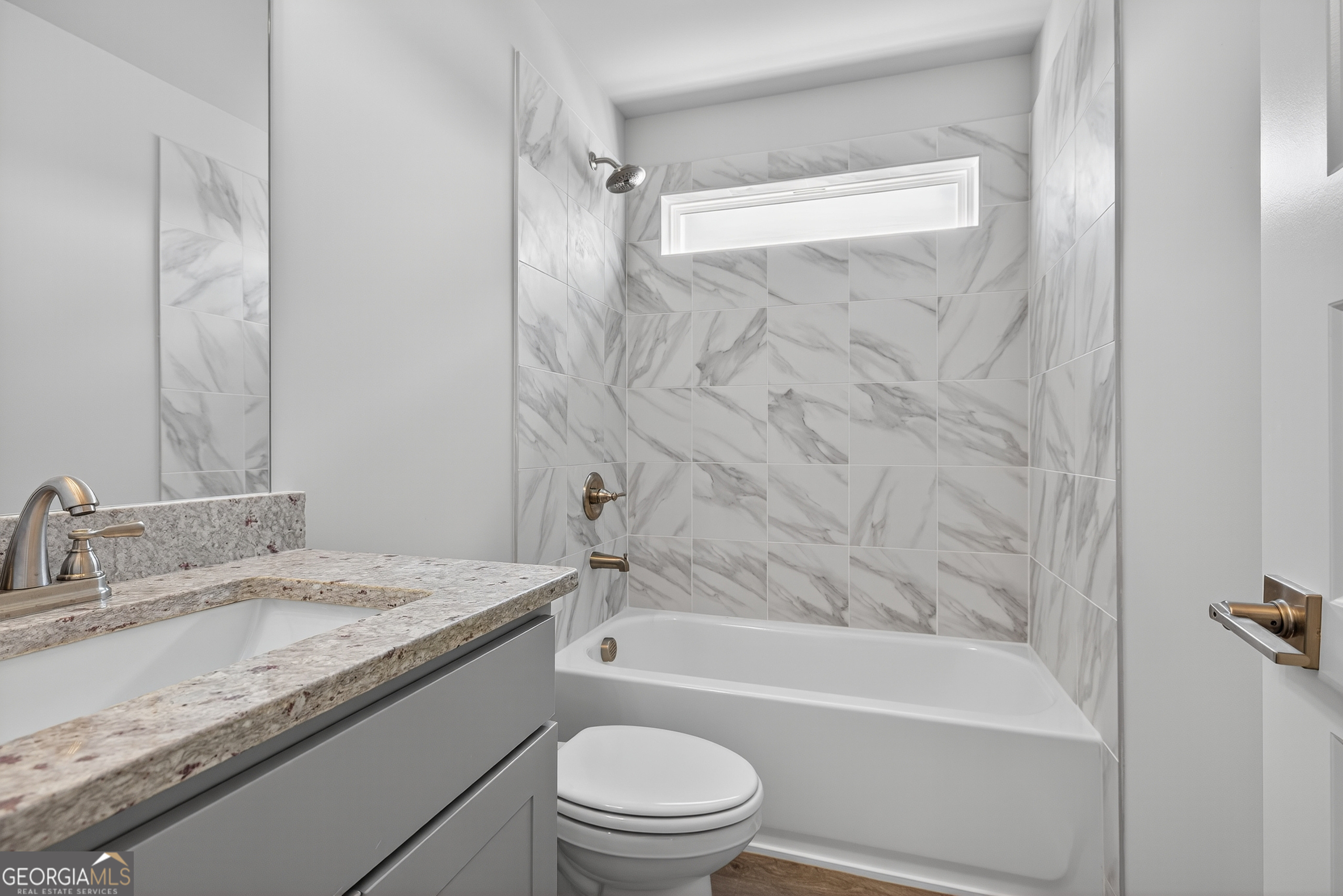 112 Patillo Manor, Unit 3 Stockbridge, GA 30281 - Photo 44 of 59 a bathroom with a granite countertop sink toilet and shower