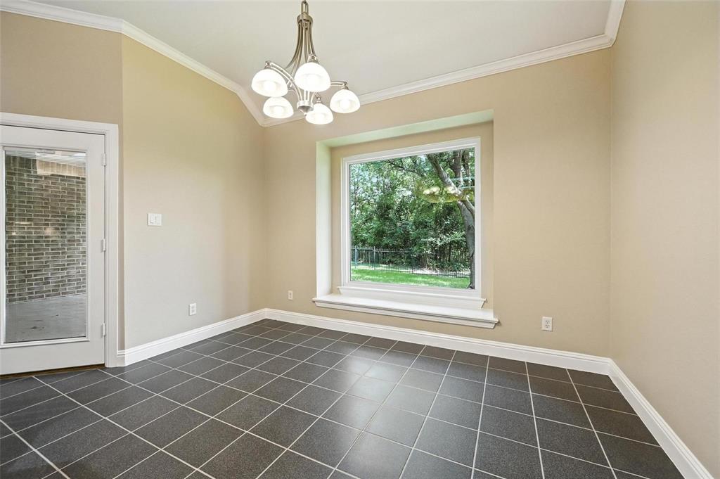 8974 Ranch Bluff Court Benbrook, TX 76126 - Photo 13 of 37 a view of an empty room with wooden floor and a window