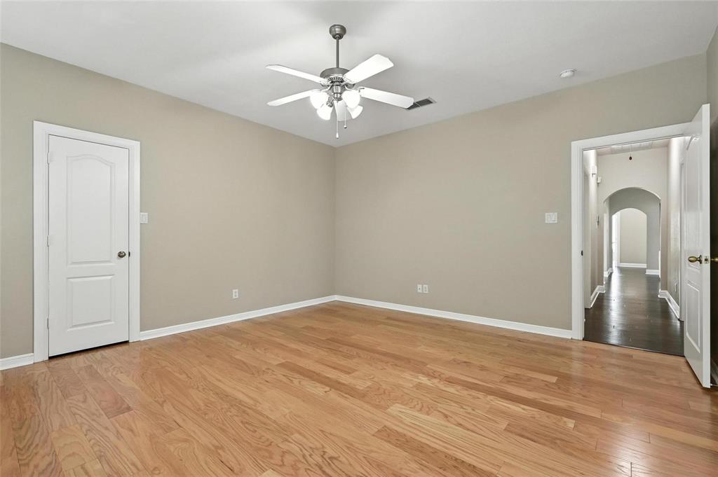 8974 Ranch Bluff Court Benbrook, TX 76126 - Photo 14 of 37 an empty room with chandelier fan and windows