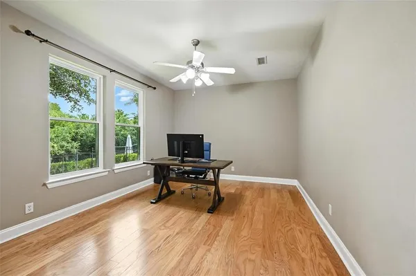 a view of a workspace with furniture and a window