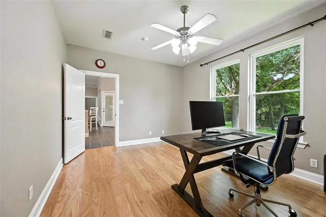 a view of a workspace with furniture and a window