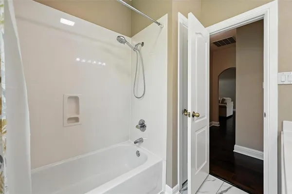 a bathroom with a glass shower door